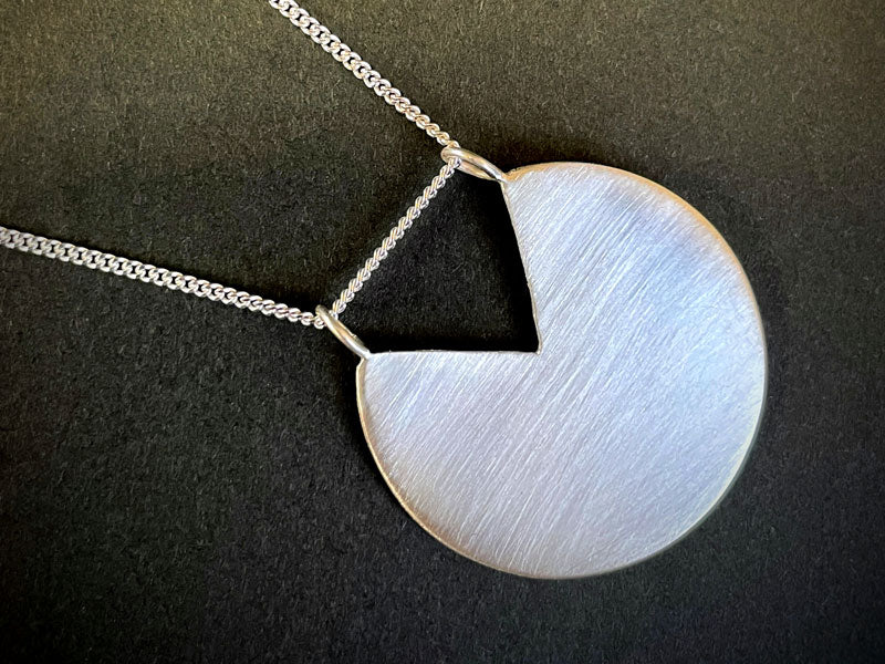 Necklace with a 925 sterling silver pendant on a dark background |