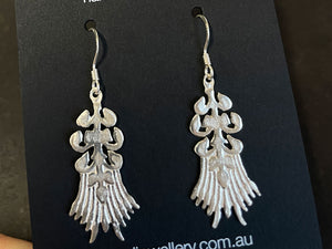 Silver earrings on a black card with 'podjewellery.com.au' text | Saw piercing