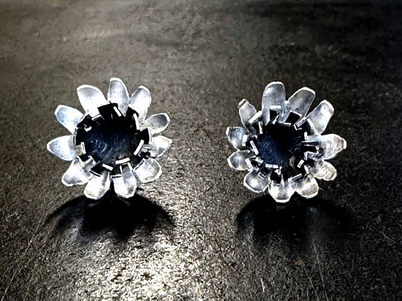 Oxidised flower earrings on a black background | piercing saw | jewellery making Classes