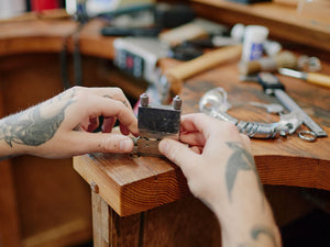 Person working with mitre vice jig on a wooden jewellers bench | jewellery supplies Sydney