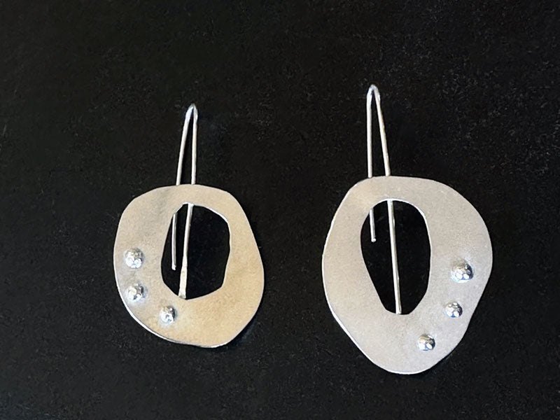 Pair of silver earrings with balls on a black background | Jewellery Short course