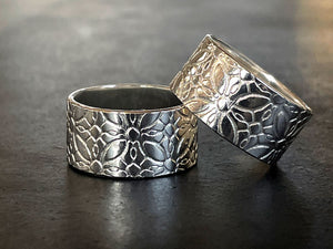 Two silver rings with intricate patterns on a dark surface | Silver Ring Making workshop