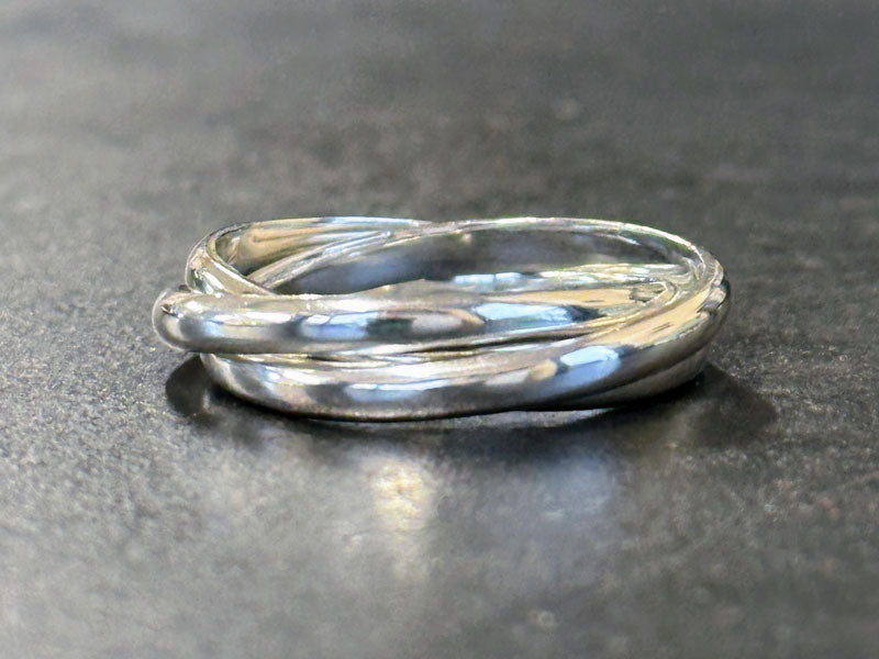 Silver ring on a dark gray surface | Silversmithing lessons