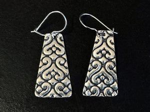 Pair of 925 silver patterned earrings oxidised with Liver of Silver Gel on a black background | Jewellery classes