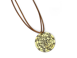 Brass pendant stamped with mandala metal stamps