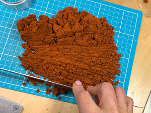 Chopping genuine Delft clay into workable pieces before packing the mould