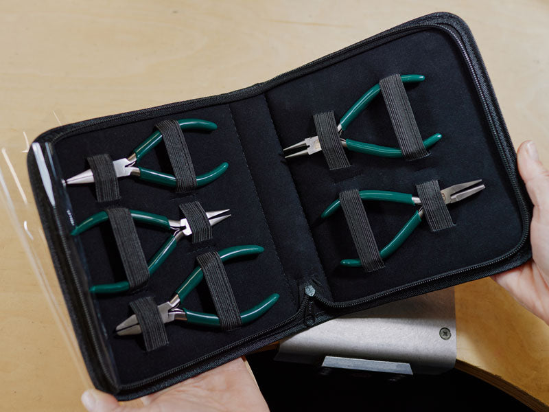 Set of five Pod jewellery pliers stored in their green carry case