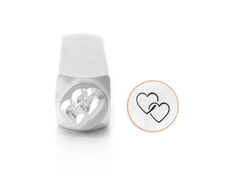 A metal stamp with a design of interlocking hearts, intended for use in crafting and jewelry making.