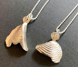 Finished shell pendants cast in metal using the Delft clay method