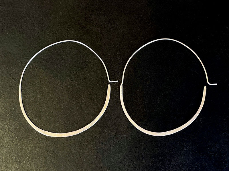 Pair of sterling silver hoop earrings on a black background | Jewellery supplies